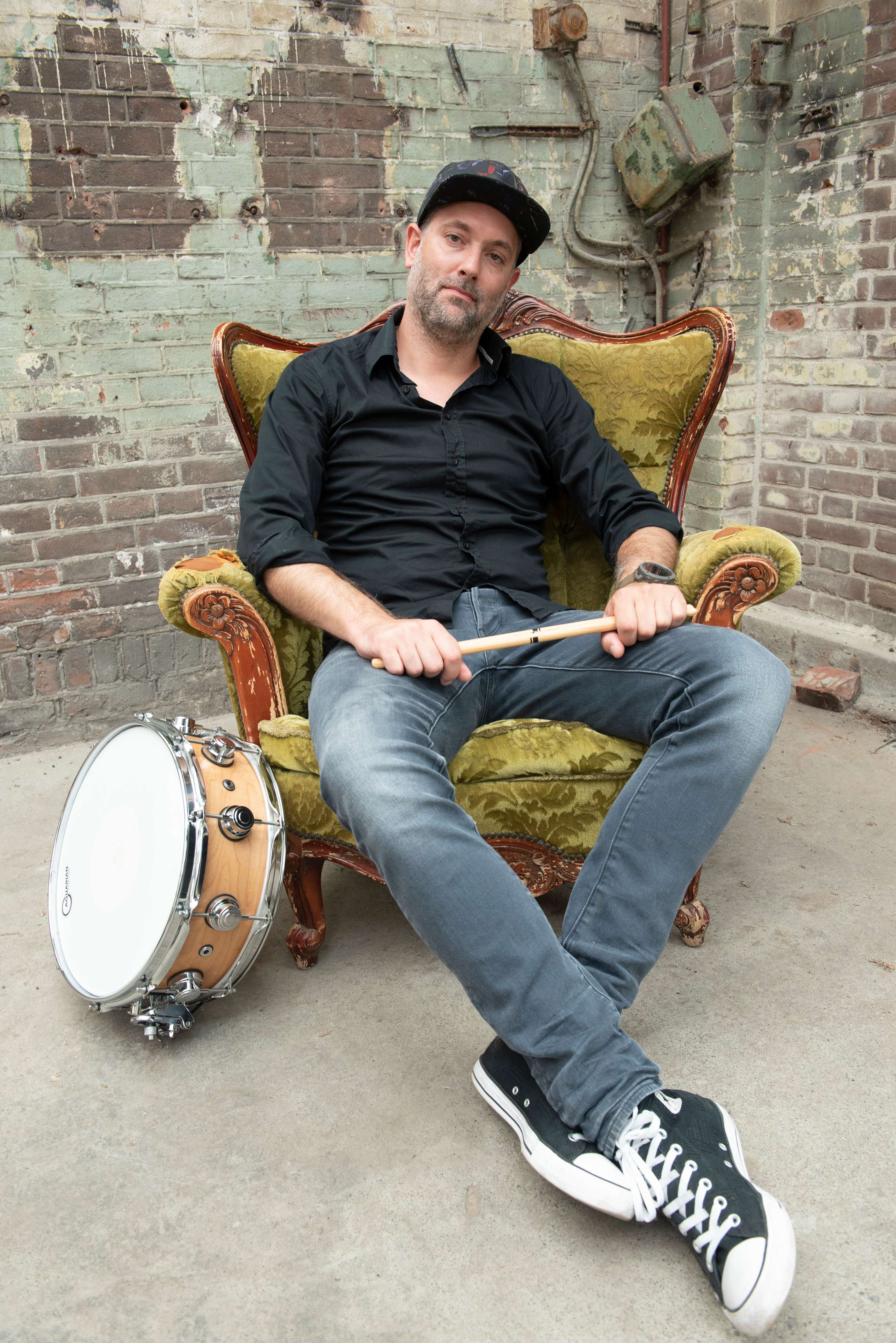 Portrait of the mix engineer holding a drumstick
